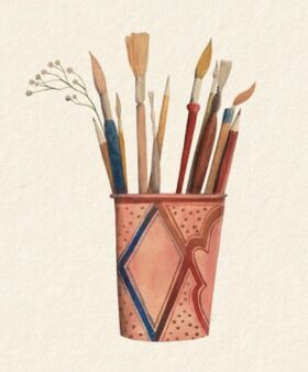 Colourfully decorated mug with paintbrushes and pens inside, against a beige background